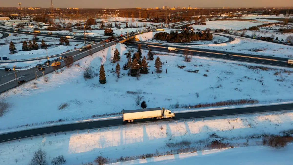 A white and blue truck on the road on a clear day